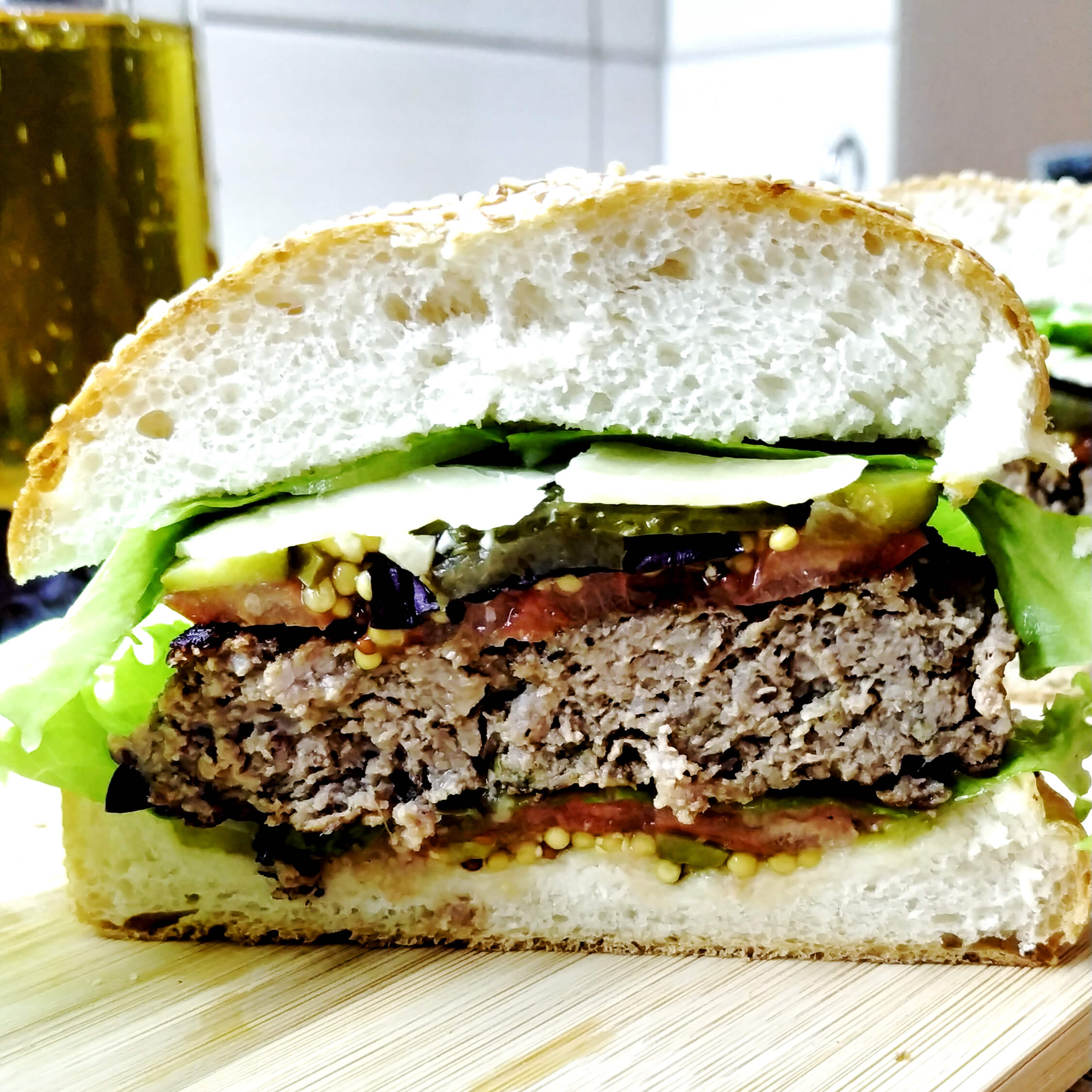 Homemade Burger with beef, pickles and Dijon mustard